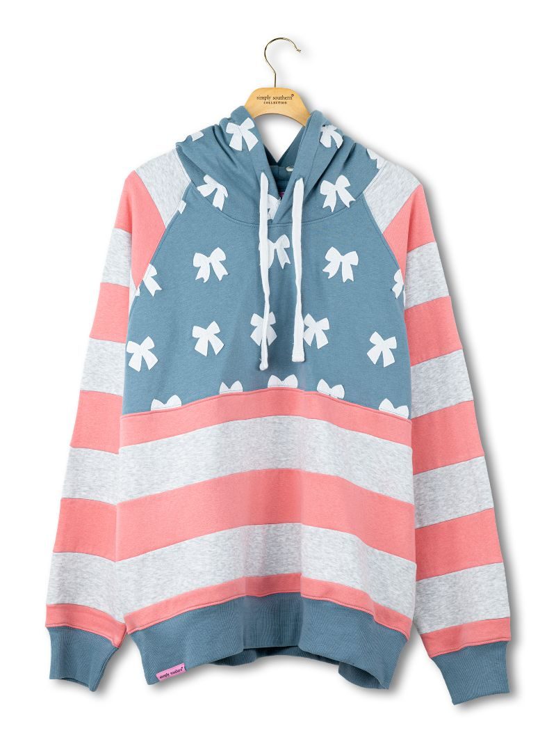 Simply Southern women’s pullover hoodie with white bow pattern, blue hood, and coral and gray striped sleeves