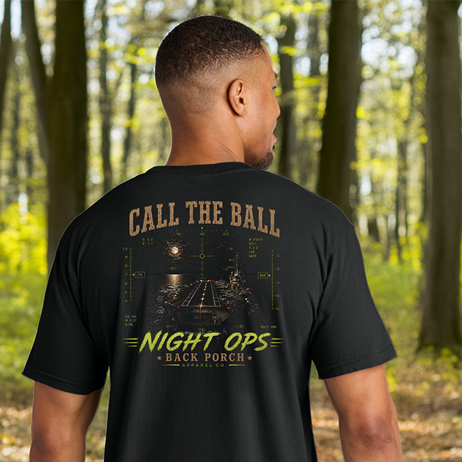 Model wearing a Back Porch Apparel Call The Ball Night Ops Comfort Colors T-Shirt