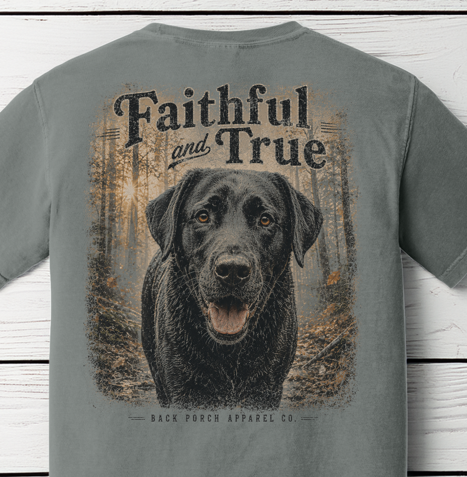 Close-up of the Faithful and True black Labrador woodland artwork printed on a Comfort Colors Grey shirt.