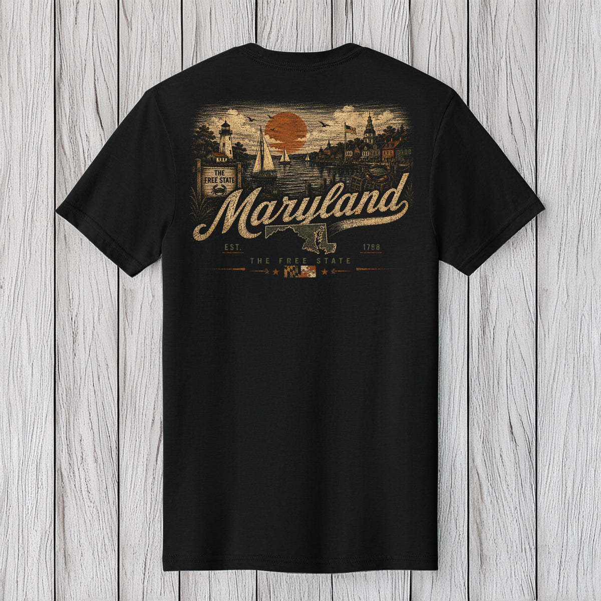 A black short-sleeve t-shirt with a vintage-style Maryland graphic on the back, displayed against a light gray wood plank background.
