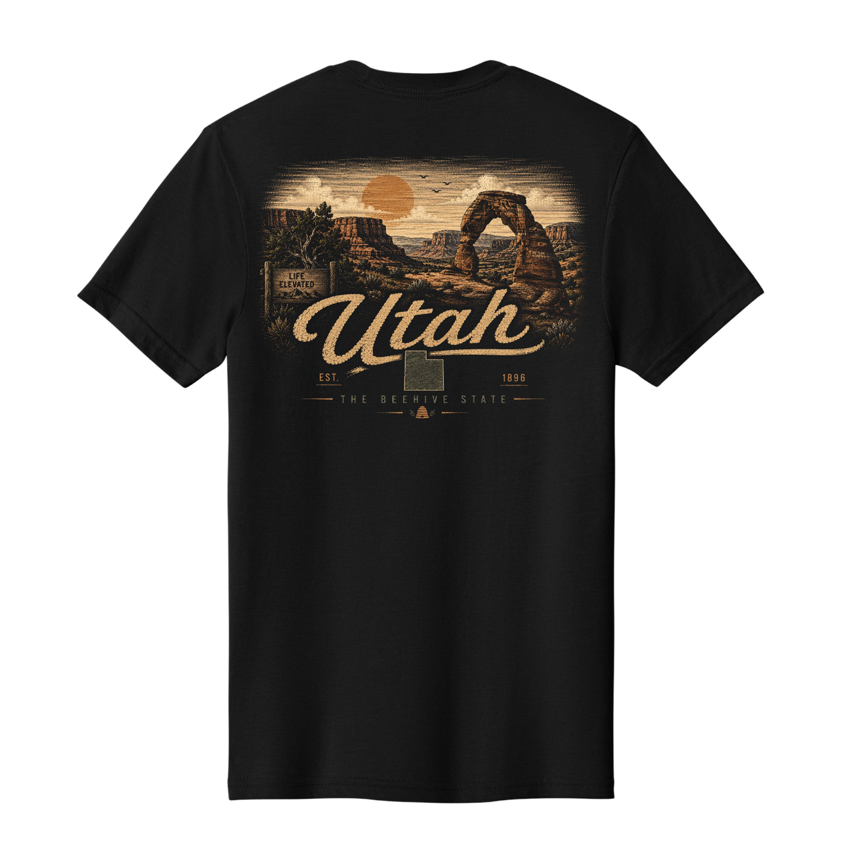 A black short-sleeve t-shirt with a large vintage-style Utah desert landscape graphic on the front, featuring Delicate Arch, a sunset, and the text 'Utah' and 'The Desert State'.