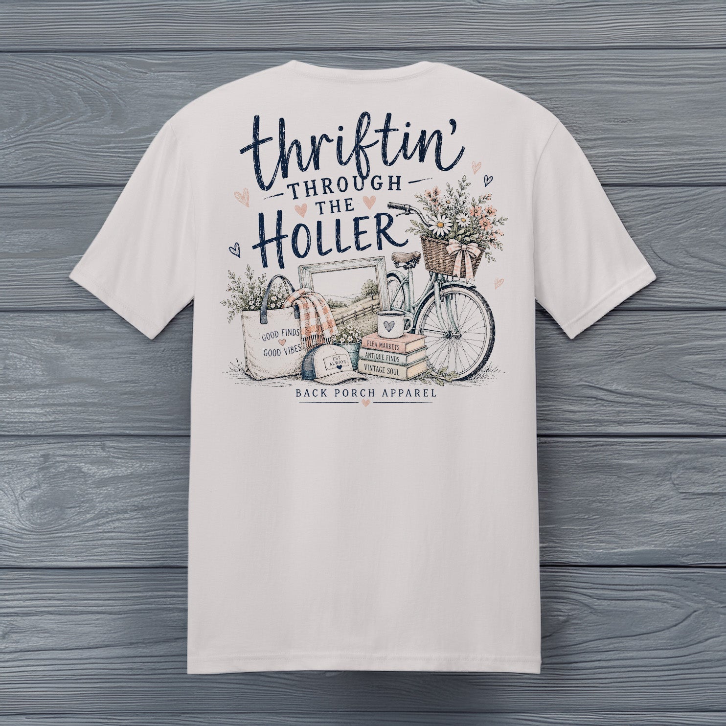 Close-up of the Thriftin' Through the Holler design featuring a vintage bicycle, antique books, flowers, flea market treasures, and rustic farmhouse artwork.