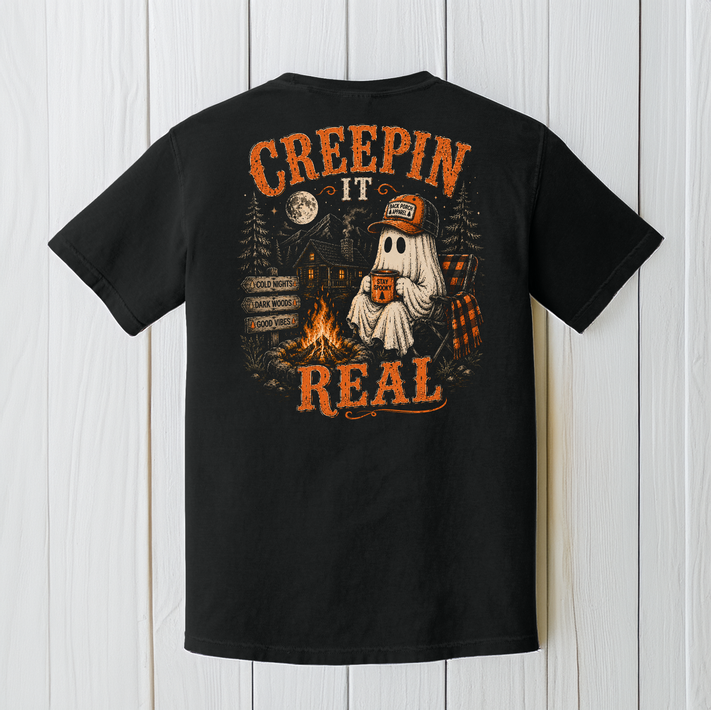 Back Porch Apparel Creepin' It Real black Comfort Colors T-Shirt with ghost sitting beside a campfire