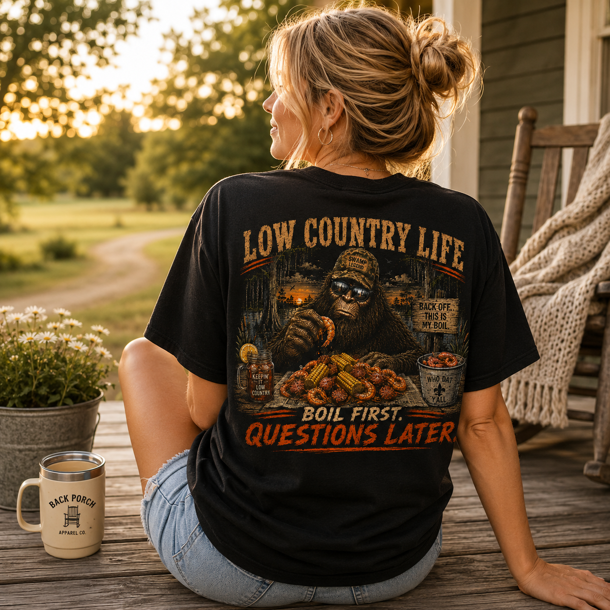 Woman wearing a Bigfoot Eating a Low Country Boil Back Porch Apparel Comfort Colors Shirt