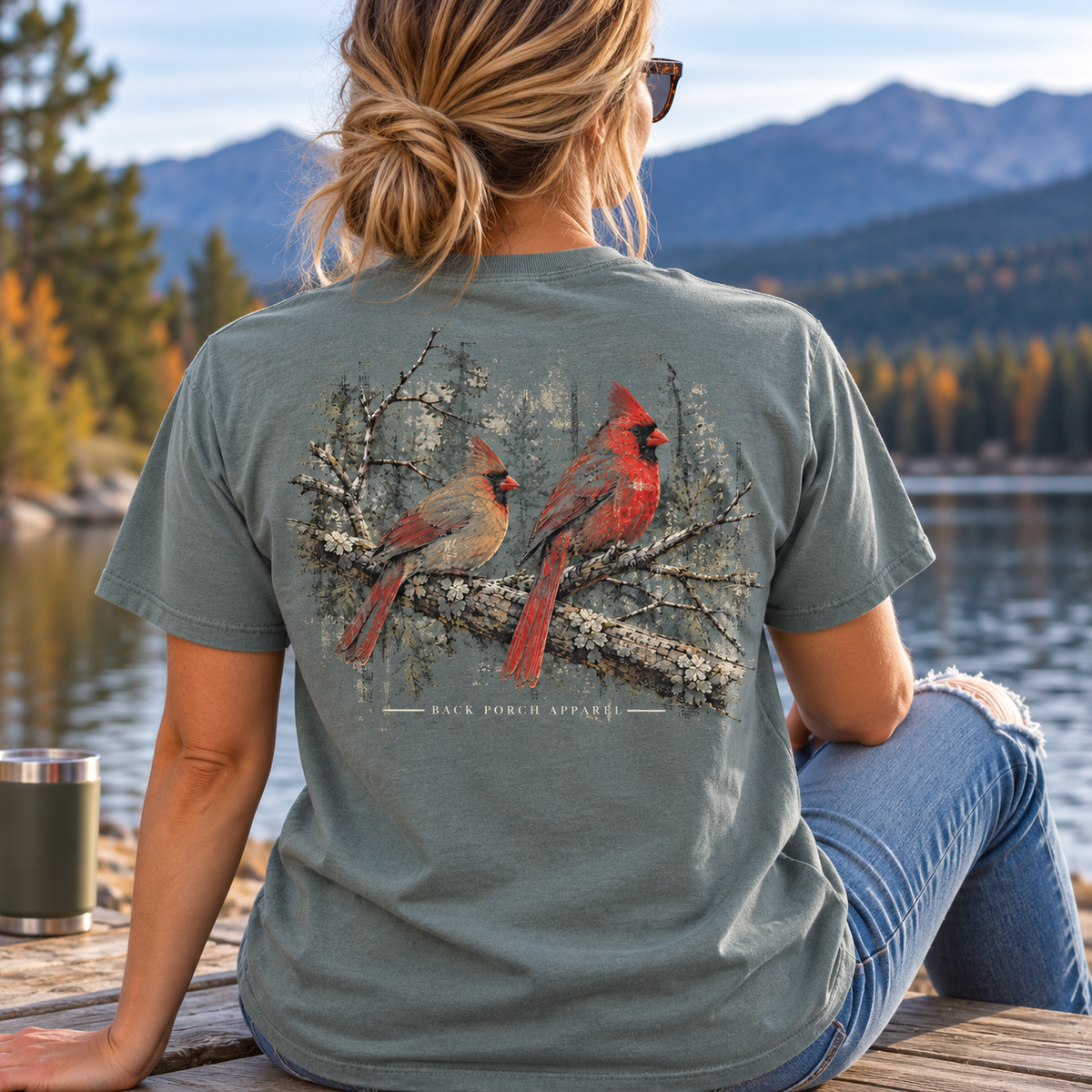 Woman wearing a Comfort Colors Grey Cardinals back Porch Apparel Shirt