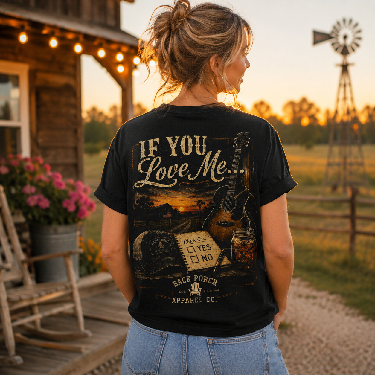 A woman stands outdoors at sunset wearing a black graphic T-shirt with the phrase “IF YOU Love Me.