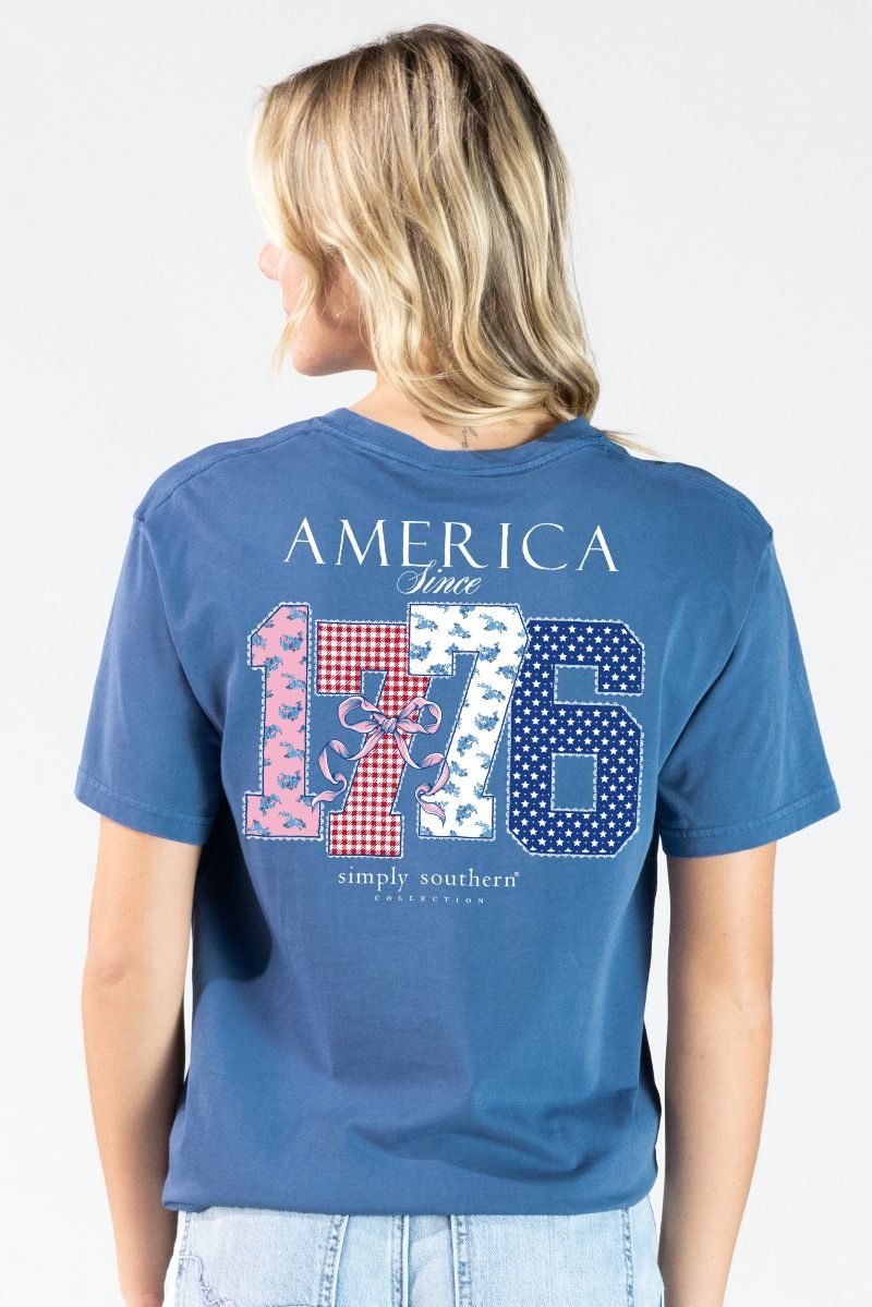 Model wearing a Simply Southern overcast blue mineral washed t-shirt with America Since 1776 design on the back