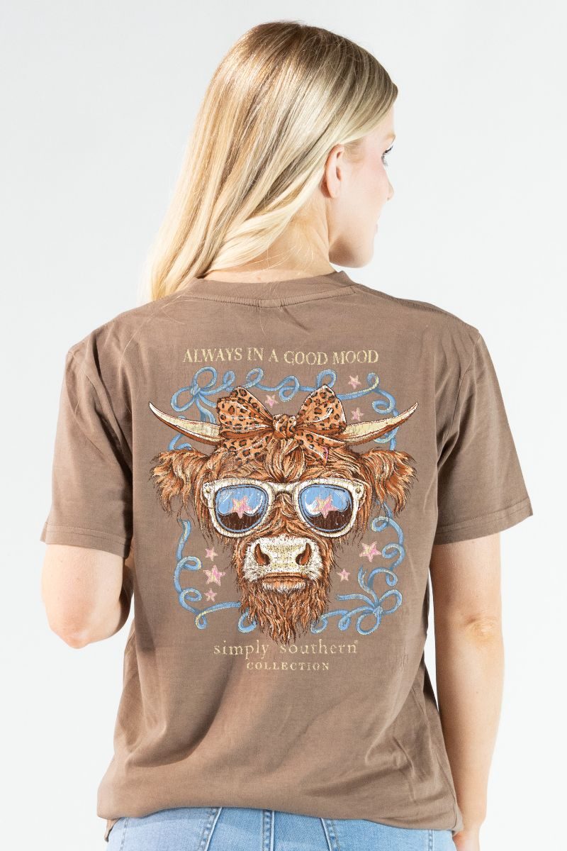 Model wearing a Simply Southern rawhide mineral washed t-shirt with Highland cow graphic on the back