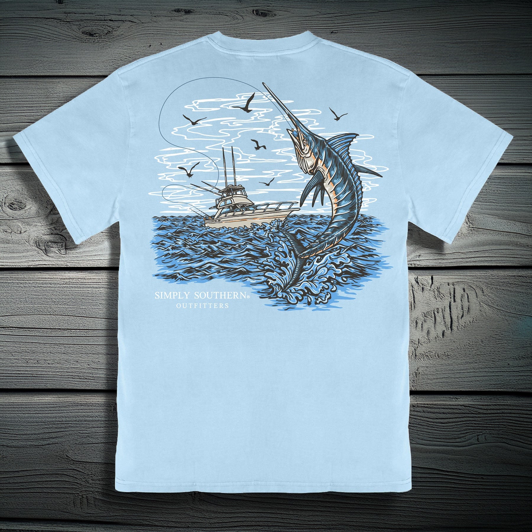 Simply Southern glacier blue t-shirt featuring marlin jumping from ocean with fishing boat graphic on back