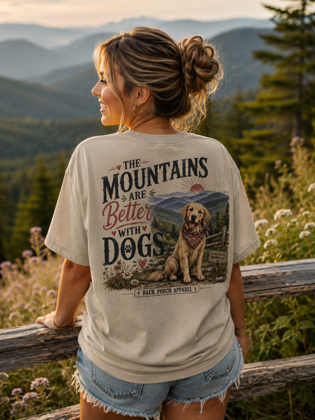 Woman wearing a The Mountains Are Better With Dogs Back Porch Apparel shirt