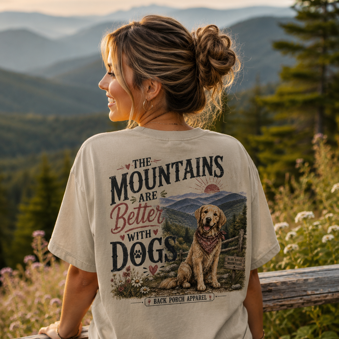 Woman wearing a The Mountains Are Better With Dogs Back Porch Apparel shirt