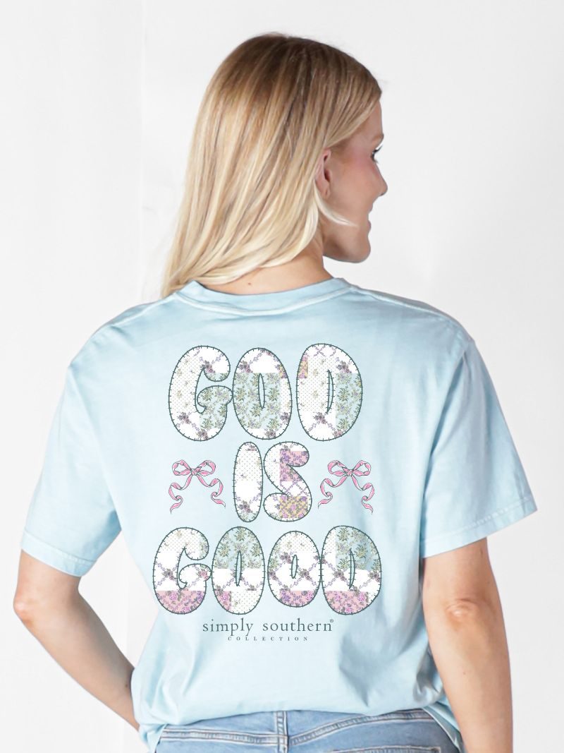 Model wearing Simply Southern ice blue God Is Good t-shirt showing floral letter and bow back design