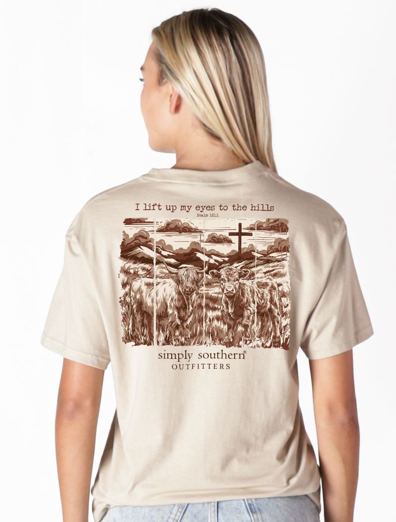 Model wearing Simply Southern clay t-shirt showing inspirational Highland cow and Psalm 121 back design