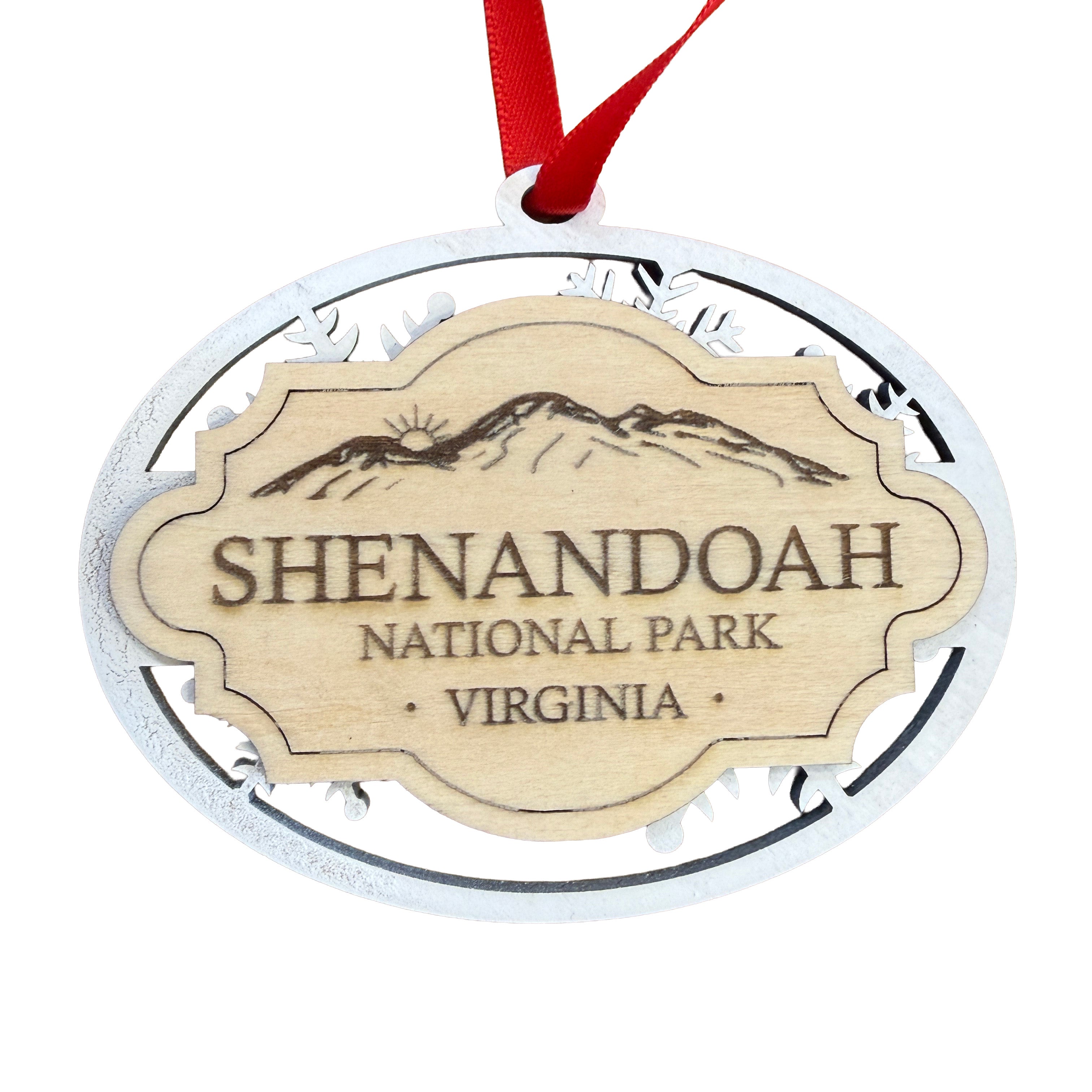 Shenandoah National Park wooden souvenir ornament with layered snowflake construction, engraved natural wood centerpiece, and red ribbon isolated on a white background.