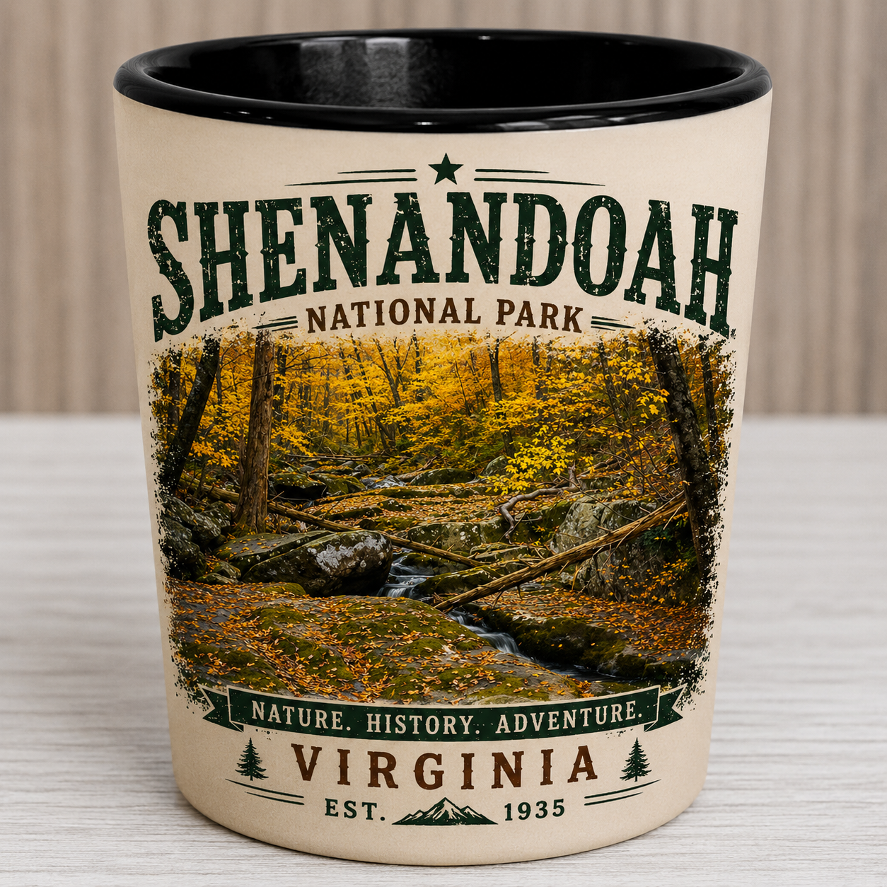 Ceramic shot glass featuring an original photograph of the autumn stream at Dark Hollow Falls in Shenandoah National Park by Scott Turnmeyer with vintage distressed typography.