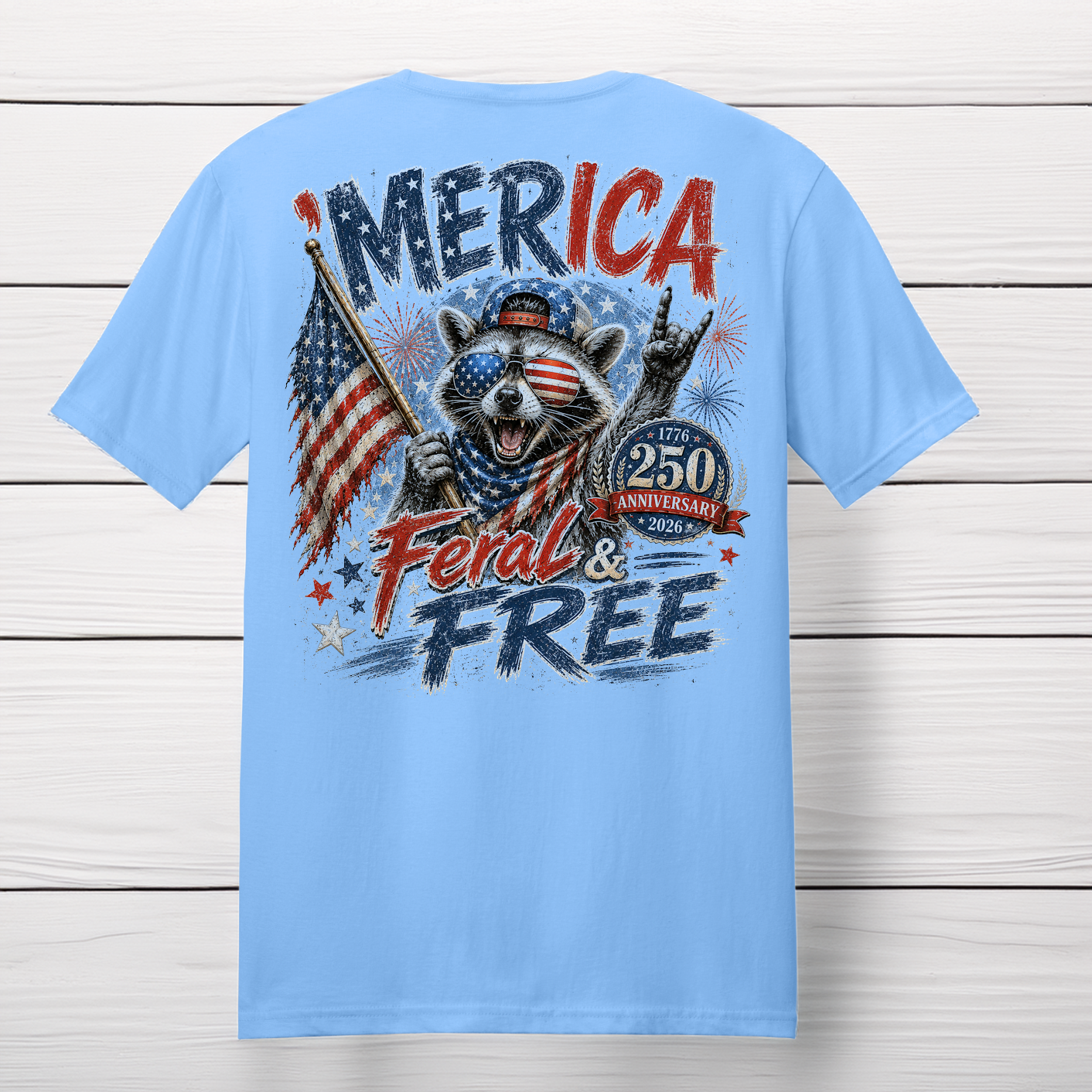 'Merica Feral and Free patriotic raccoon graphic t-shirt featuring a raccoon wearing American flag sunglasses, holding a U.S. flag, and celebrating America's 250th Anniversary