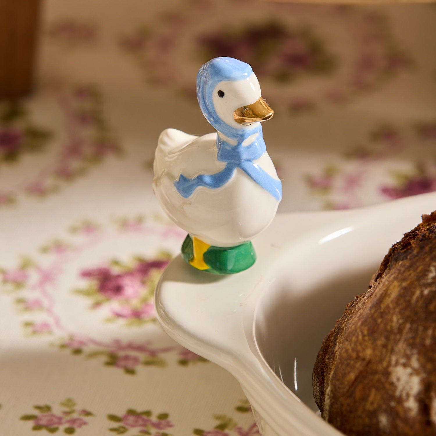 Nora Fleming Porch Pal goose mini wearing blue bonnet on Nora Fleming platter