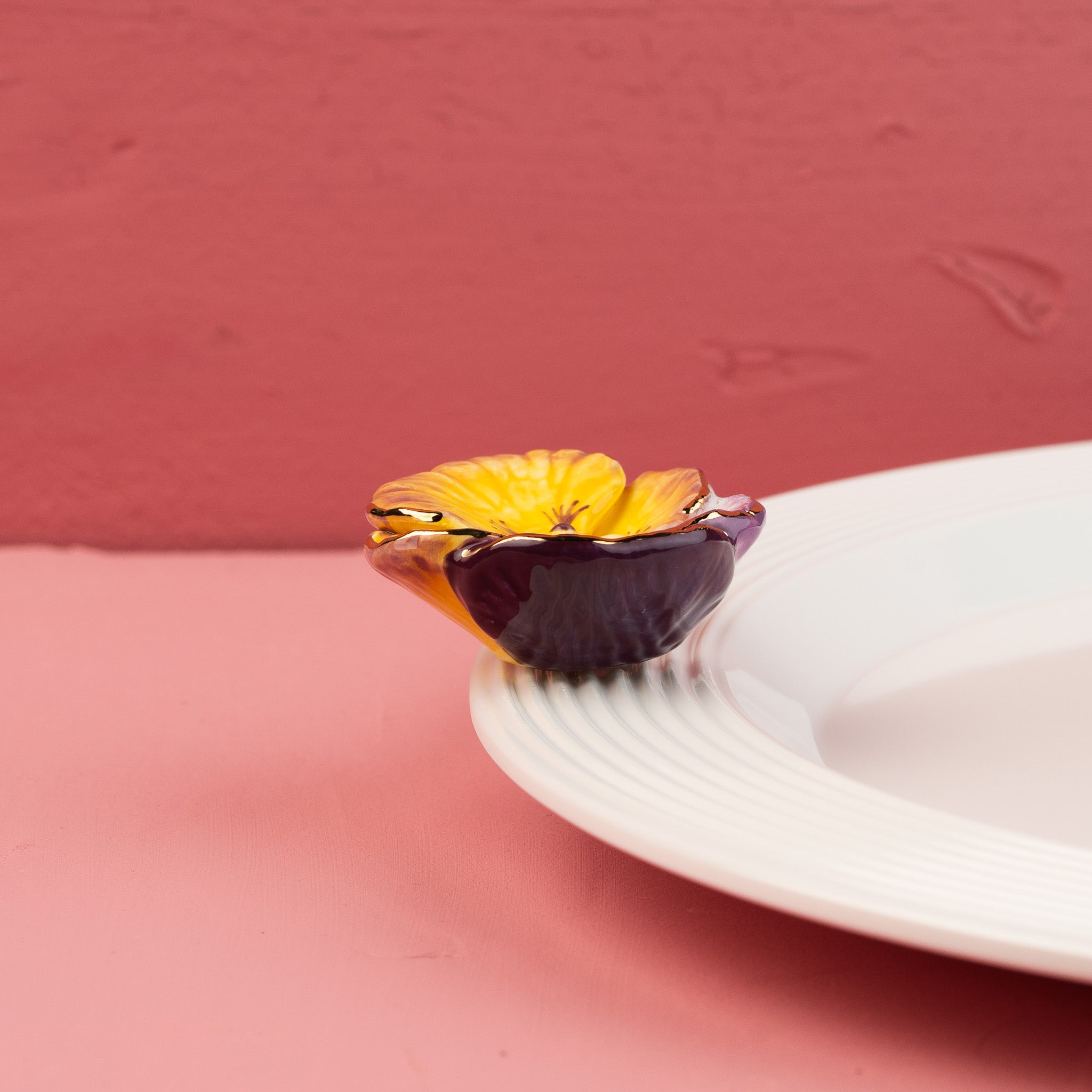 Nora Fleming Pansy Pop Mini displayed on a white Nora Fleming platter, perfect for spring entertaining, Easter celebrations, and floral-inspired décor