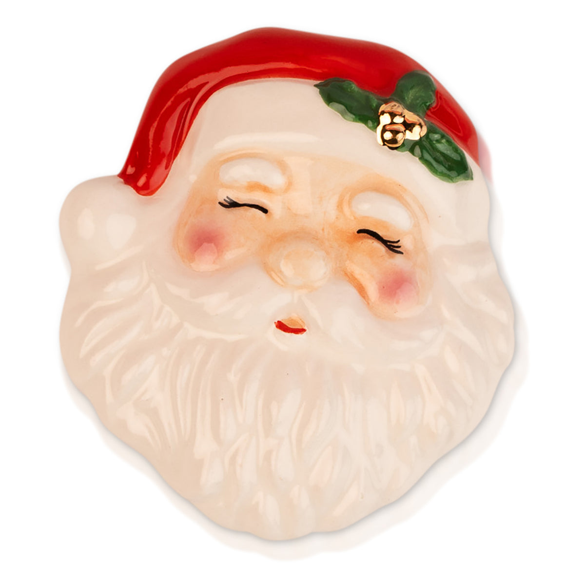 A ceramic Santa Claus face ornament or plaque featuring a red hat with green holly leaves and gold berries, a white beard, and closed smiling eyes, shown on a white background.