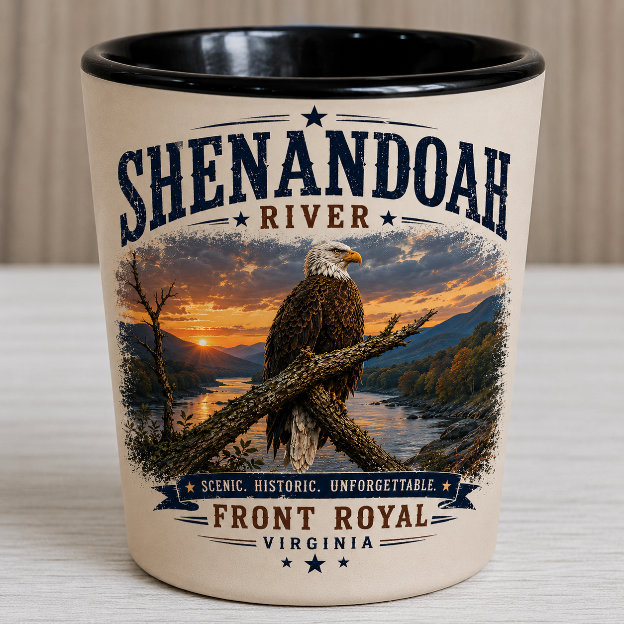 Ceramic shot glass featuring a bald eagle perched above the Shenandoah River at sunset with Front Royal Virginia typography and a black interior.