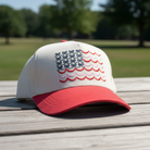 Simply Southern cream and red trucker hat featuring an embroidered American flag made of bows and wavy stripes