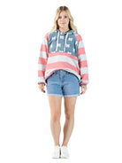 Model wearing Simply Southern bow print pullover hoodie with striped sleeves and drawstring hood