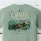 Shipwreck coastal graphic inspired by Aruba waters with vintage nautical artwork on a Comfort Colors Bay shirt.