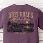 Close-up of the Dirt Roads After Dark graphic on a Berry Comfort Colors t-shirt showing an old pickup truck, black Labrador, moonlit lake, and Back Porch Apparel Co. branding.