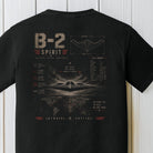 Detailed B-2 Spirit stealth bomber graphic with tactical blueprint artwork on a black Comfort Colors shirt.
