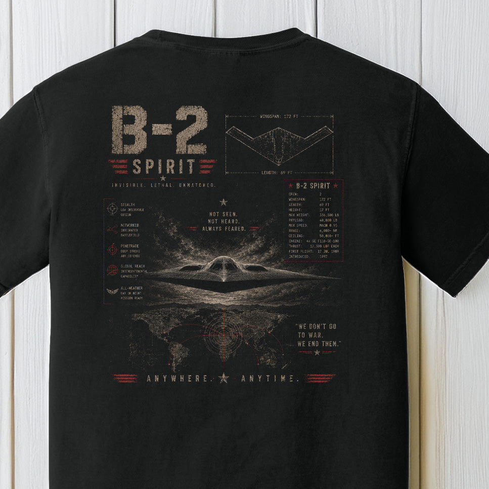 Detailed B-2 Spirit stealth bomber graphic with tactical blueprint artwork on a black Comfort Colors shirt.
