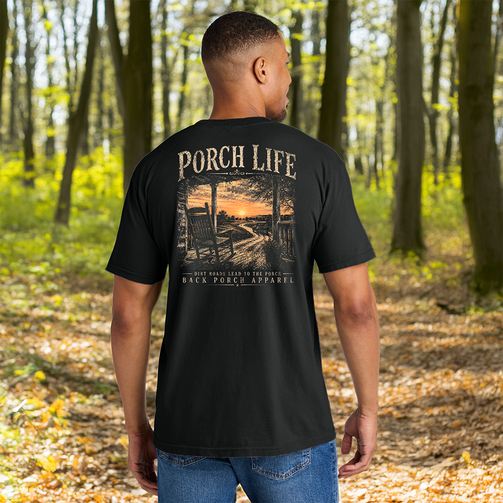 Model wearing a Back Porch Apparel Porch Life Dirt Roads Lead to the Porch Comfort Colors T-Shirt