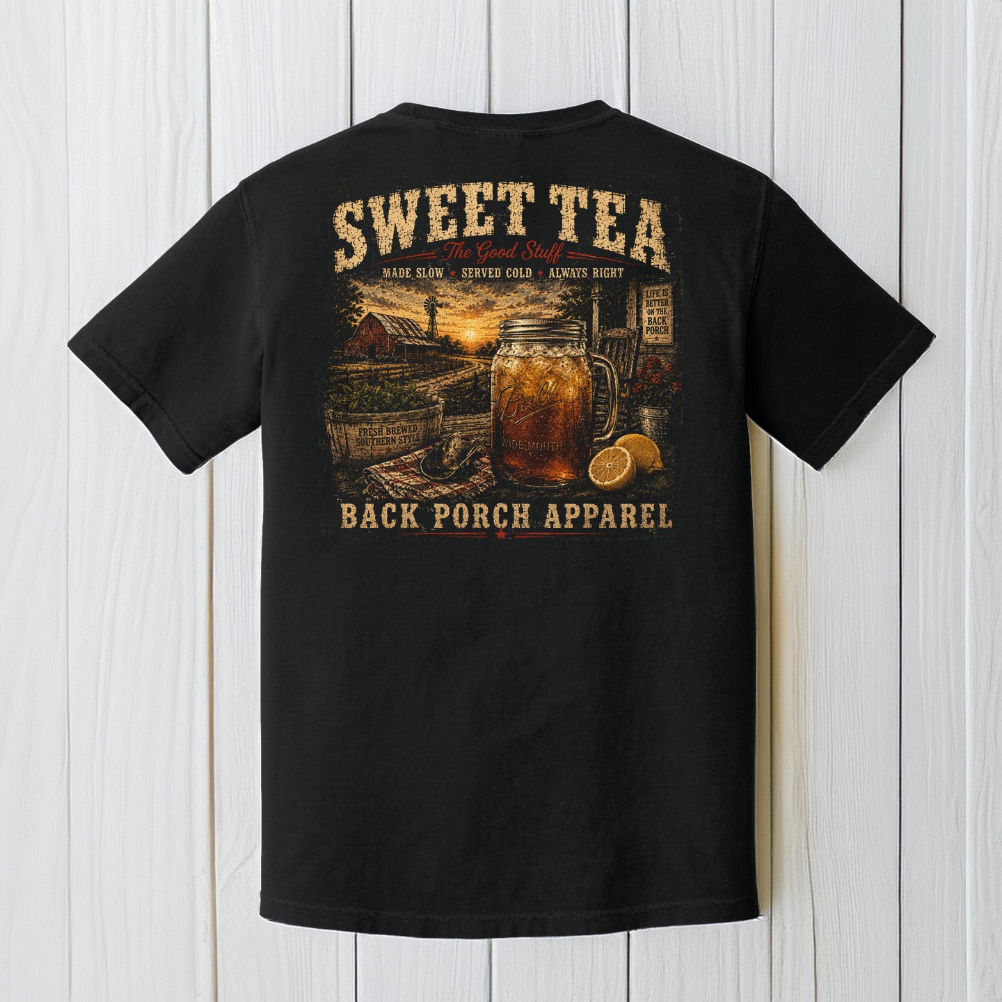 Black Comfort Colors t-shirt hanging on a wood background featuring a vintage sweet tea porch life graphic with mason jar and southern farmhouse artwork.