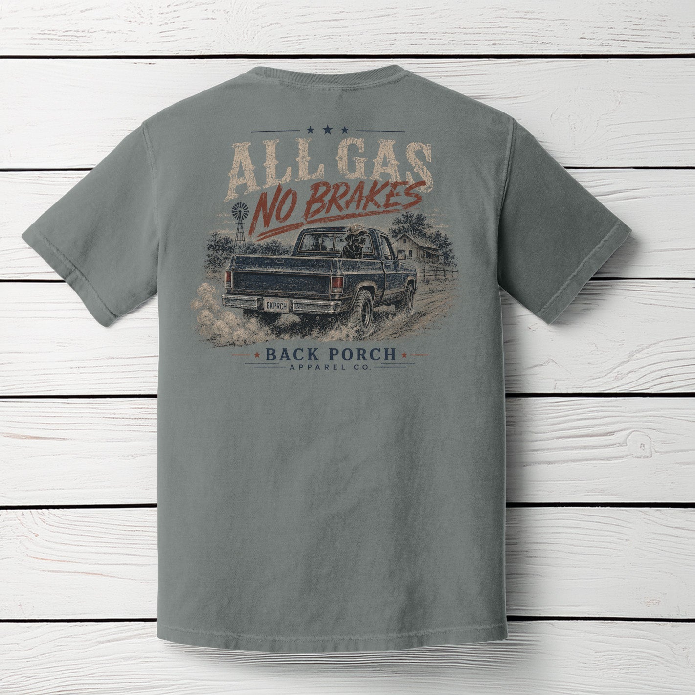 Back view of the Back Porch Apparel All Gas No Brakes Comfort Colors Grey t-shirt featuring a vintage square-body pickup truck, country farmhouse, windmill, and distressed country graphic.