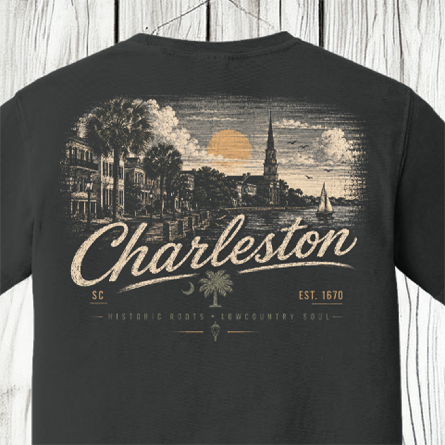 A dark charcoal gray t-shirt shown from the back, featuring a vintage-style graphic print of a Charleston harbor scene with palm trees, a church steeple, sailboats, and the word 'Charleston' in large cream script.