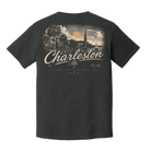 A dark charcoal gray t-shirt shown from the back, featuring a large vintage-style graphic of Charleston, South Carolina, with a scenic illustration and cream-colored text.