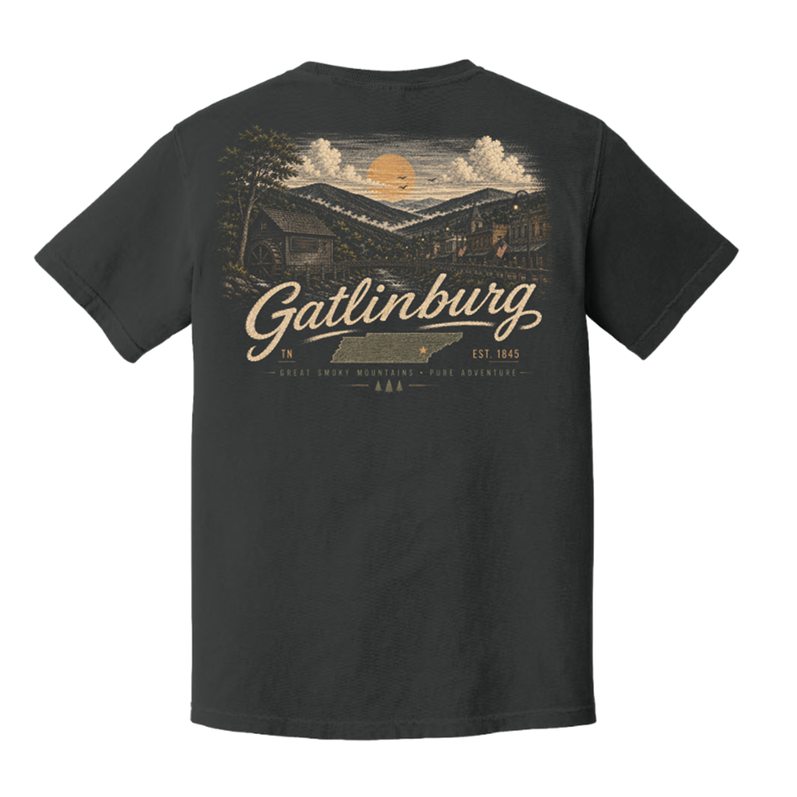 A dark charcoal gray t-shirt shown from the back, featuring a large vintage-style graphic of a mountain cabin under a sunset sky with the text 'Gatlinburg' and 'Est. 1845'.
