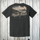 A dark charcoal gray t-shirt shown from the back, featuring a vintage-style graphic of a beach sunset with the text 'Myrtle Beach' and 'Eastwater Gap - Treasure Coast' printed in beige and white.
