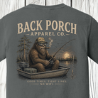 Close-up of the Bigfoot fishing graphic showing Bigfoot in a jon boat at sunset with a fishing rod, tackle box, and the phrase "Good Times. Tight Lines. No WiFi." on a Pepper Comfort Colors t-shirt.
