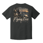 A dark charcoal gray t-shirt shown from the back, featuring a large graphic print of a bald eagle flying over a river landscape at sunset with the text 'Flying Free' and 'Menden Hosiery' printed below.