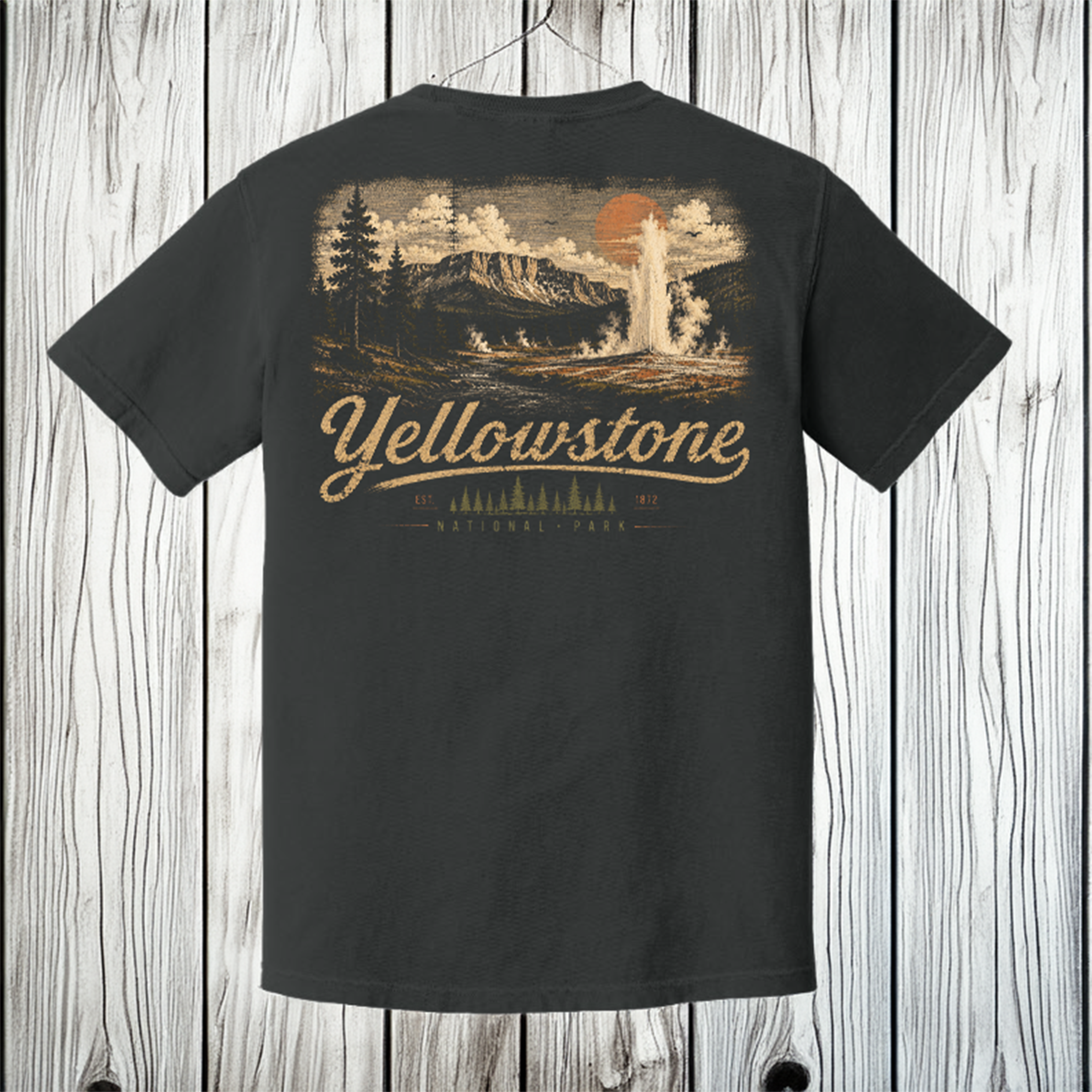 A dark charcoal gray t-shirt shown from the back, featuring a large vintage-style Yellowstone National Park graphic in beige and orange. The shirt is hanging on a wooden hanger against a light gray wood plank background.
