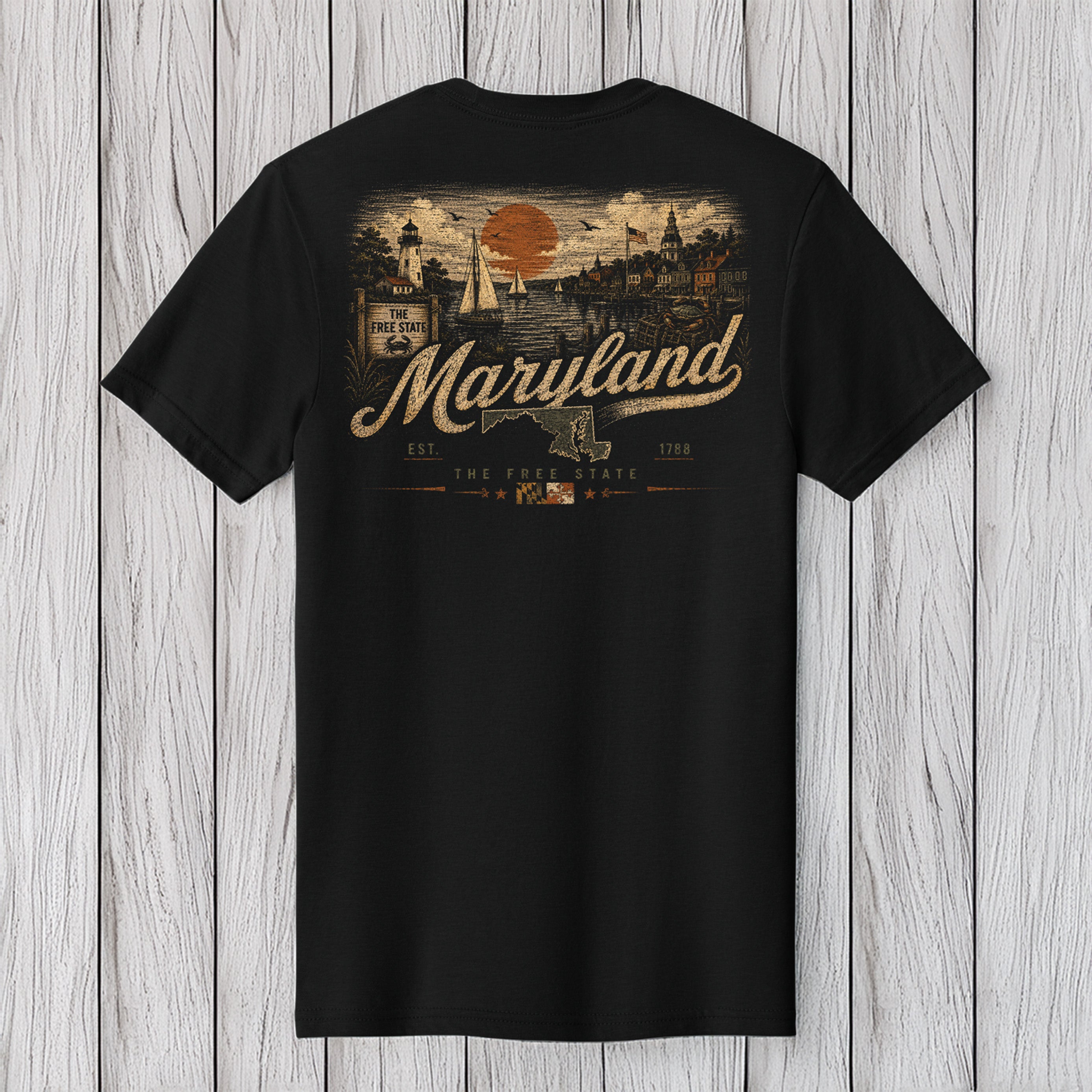 A black short-sleeve t-shirt with a vintage-style Maryland graphic on the back, displayed against a light gray wood plank background.