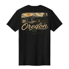 A black short-sleeve t-shirt with a large back graphic depicting a scenic Oregon landscape with a mountain, sunset, and the word 'Oregon' in a distressed beige font.