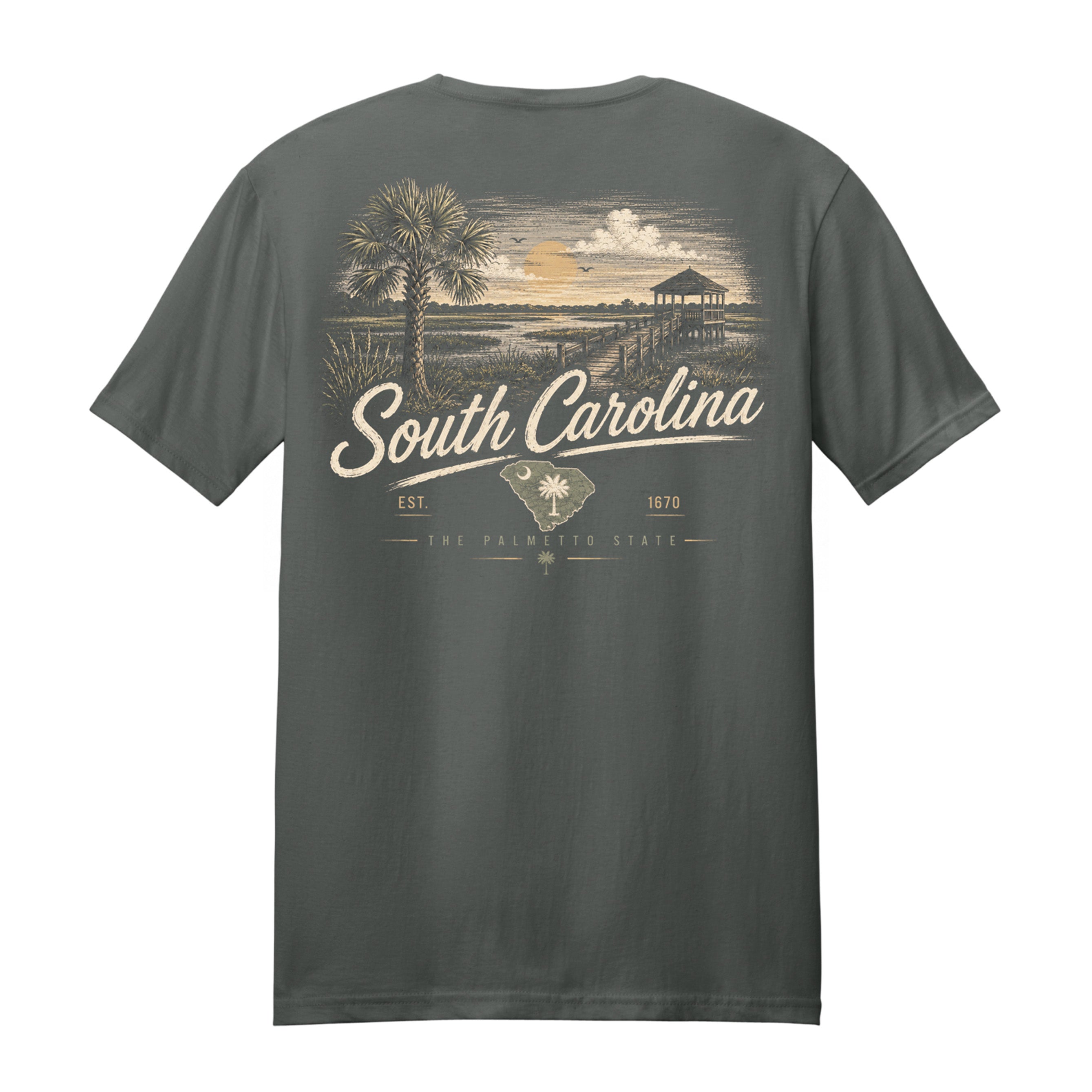 A dark gray t-shirt shown from the back, featuring a vintage-style graphic print of a South Carolina beach scene with a palm tree, sunset, and the text 'South Carolina' in cream lettering.