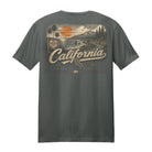 A dark gray crewneck t-shirt showing the back graphic, which features a vintage-style California landscape illustration with a large orange sun, palm trees, and the word 'California' in a cursive font.