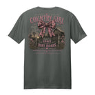 Back view of a charcoal gray t-shirt displayed on a white background featuring a distressed pink camouflage bow, rustic barn artwork, and “Country Girl Raised on Grace & Dirt Roads” design by Back Porch Apparel.