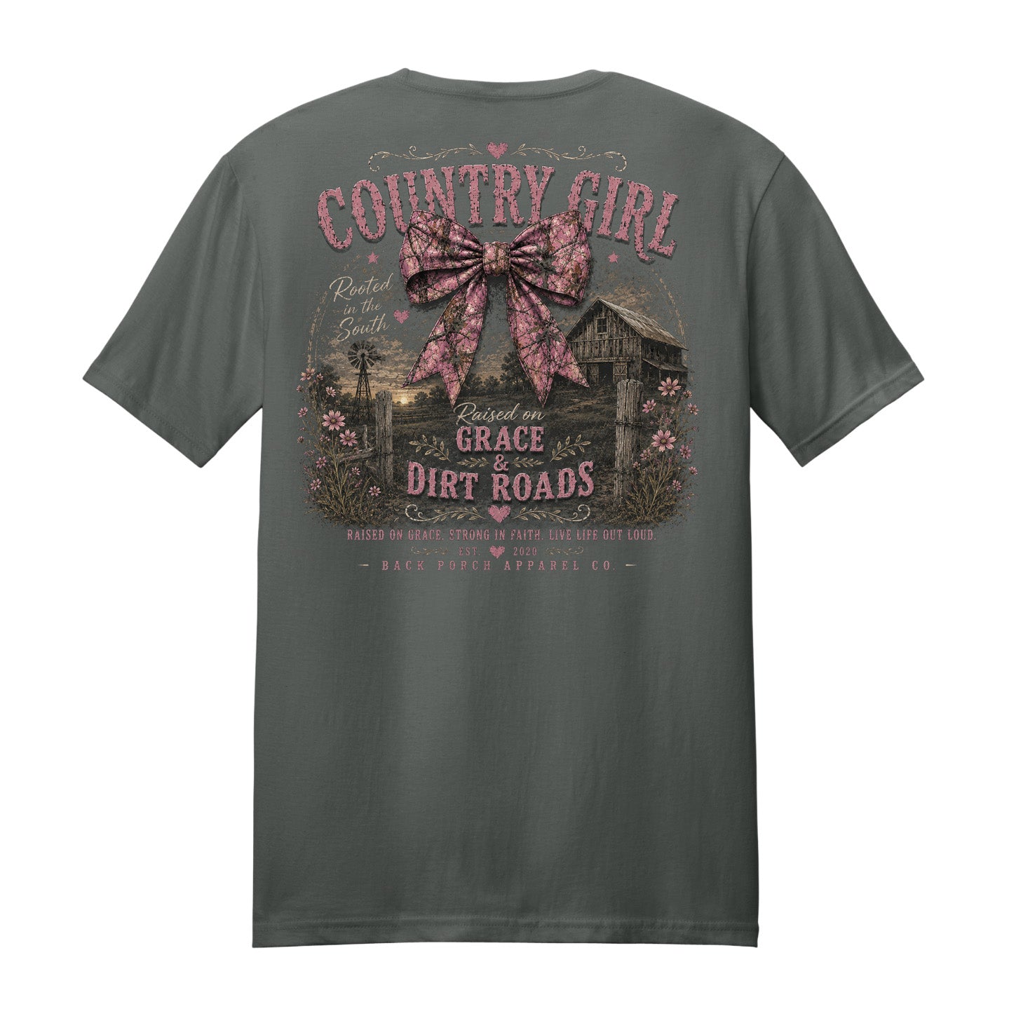 Back view of a charcoal gray t-shirt displayed on a white background featuring a distressed pink camouflage bow, rustic barn artwork, and “Country Girl Raised on Grace & Dirt Roads” design by Back Porch Apparel.
