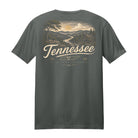 A dark gray short-sleeve t-shirt shown from the back, featuring a vintage-style Tennessee landscape graphic in beige and cream tones with the word 'Tennessee' printed across the center.