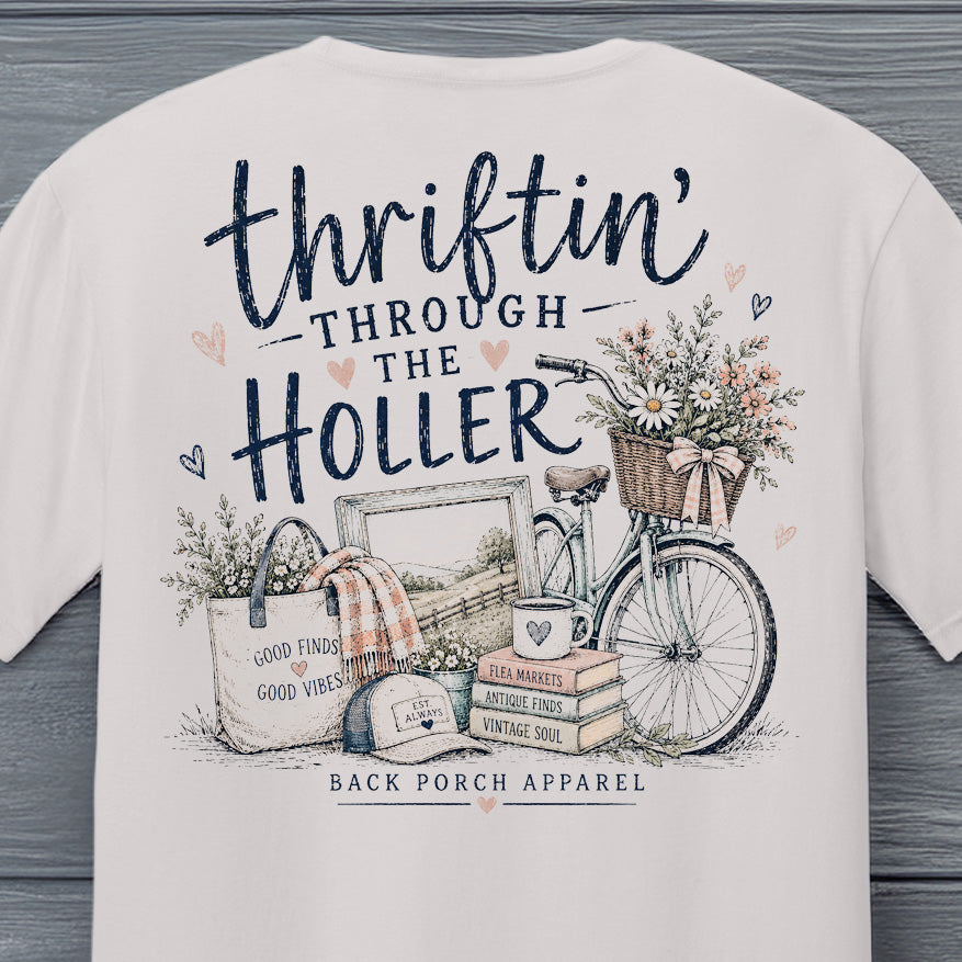 Back view of the Thriftin' Through the Holler vintage thrift shopping t-shirt displayed against a rustic wood background.