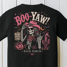 Close-up of Boo-Yaw Western Halloween shirt design with skeleton cowgirl pink cowboy hat pumpkin and cactus