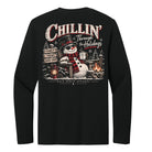 A black long-sleeve t-shirt shown from the back, featuring a large graphic print with a snowman, a campfire, and the text 'Chillin' Through the Holidays' and 'Black Forest Apparel'.